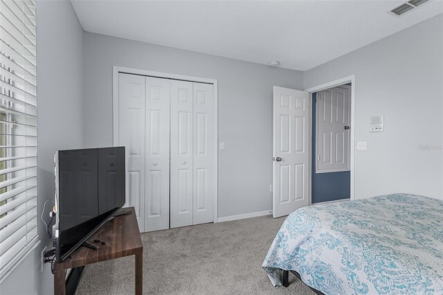 carpeted bedroom featuring a closet