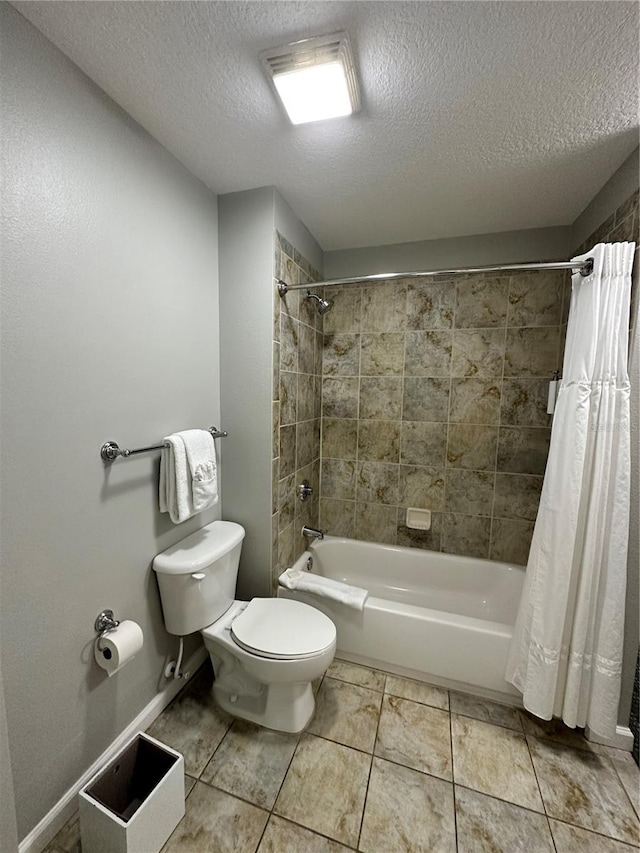 bathroom featuring tile patterned flooring, shower / bath combination with curtain, toilet, and a textured ceiling