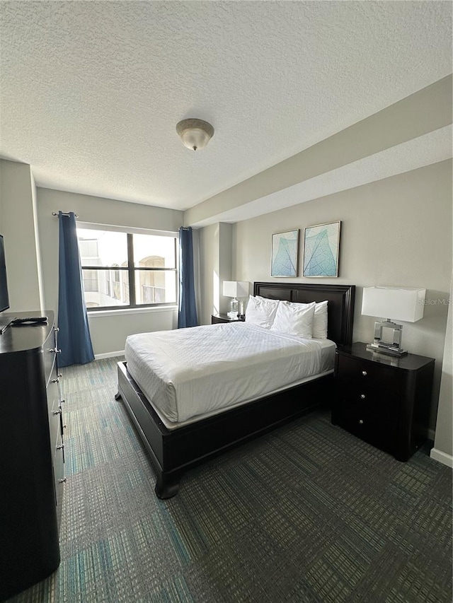 carpeted bedroom with a textured ceiling and multiple windows