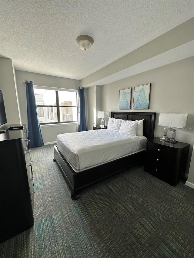 carpeted bedroom with a textured ceiling