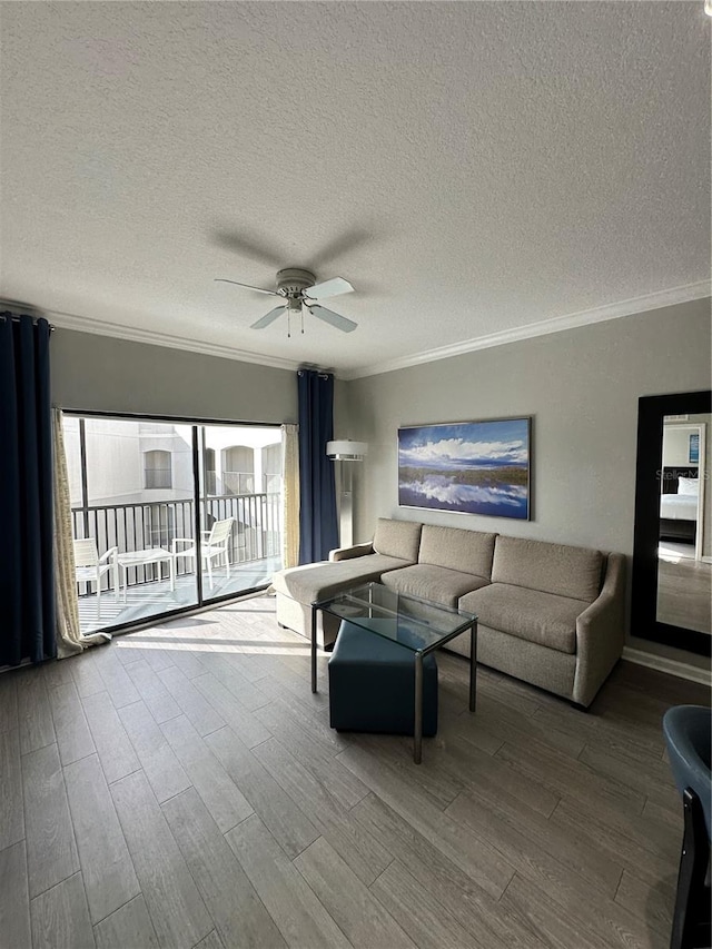 living room featuring a textured ceiling, light hardwood / wood-style floors, ceiling fan, and ornamental molding