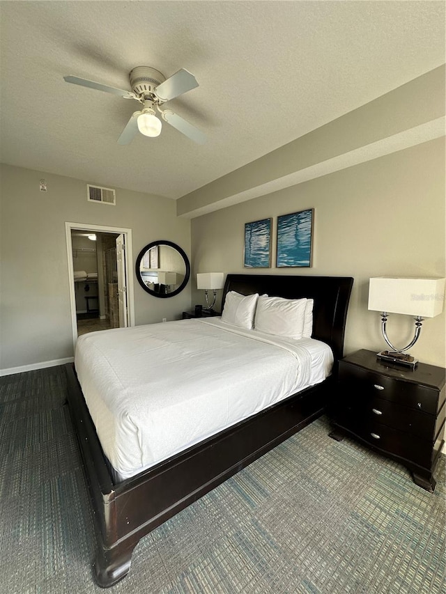 bedroom featuring ceiling fan and a textured ceiling