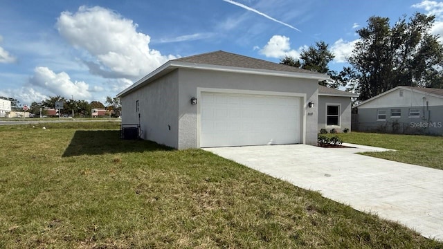 view of side of property with a yard and a garage