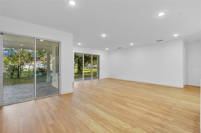 unfurnished room with light hardwood / wood-style floors