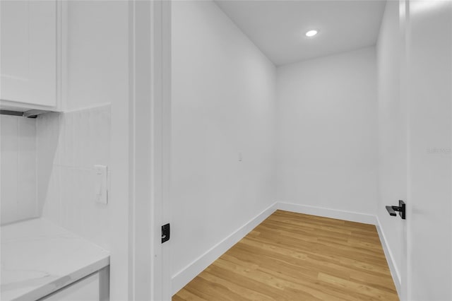 laundry area featuring light wood-type flooring