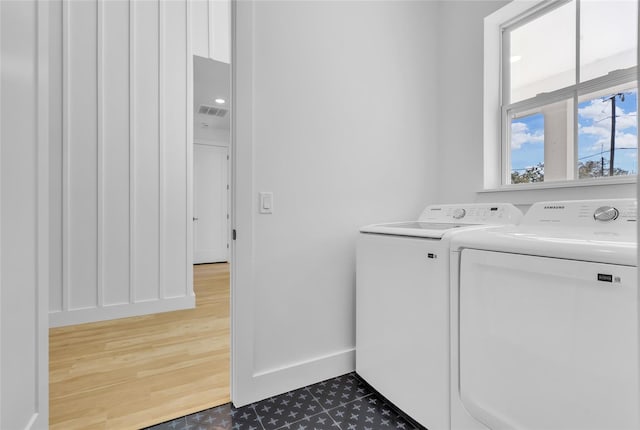 laundry area featuring independent washer and dryer and dark wood-type flooring