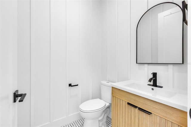 bathroom featuring tile patterned floors, vanity, and toilet