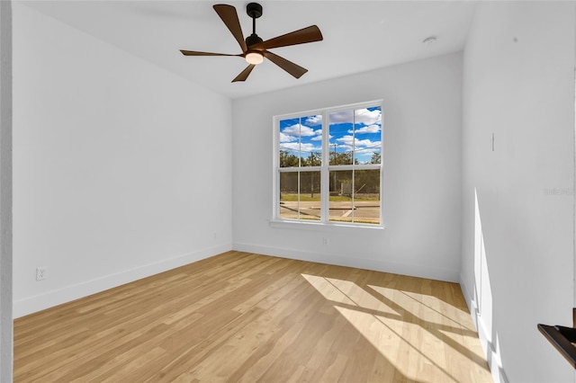 spare room with ceiling fan and light wood-type flooring