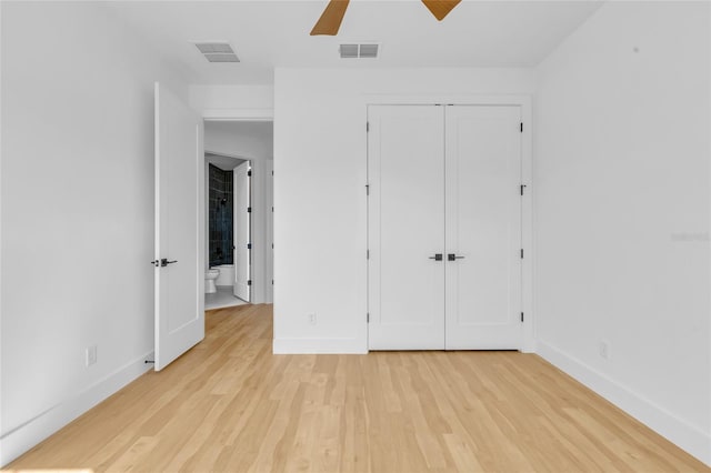 unfurnished bedroom with a closet, light hardwood / wood-style flooring, and ceiling fan