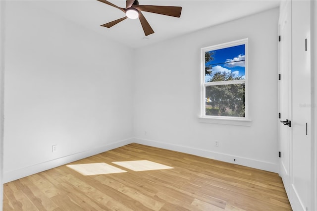 spare room with light wood-type flooring and ceiling fan