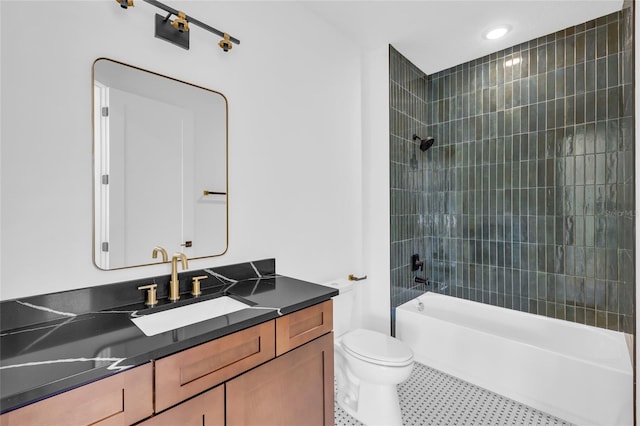 full bathroom featuring toilet, vanity, and tiled shower / bath