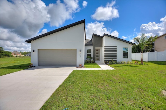 contemporary house featuring a front yard and a garage