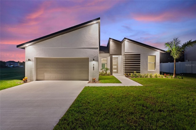 contemporary house with a lawn and a garage