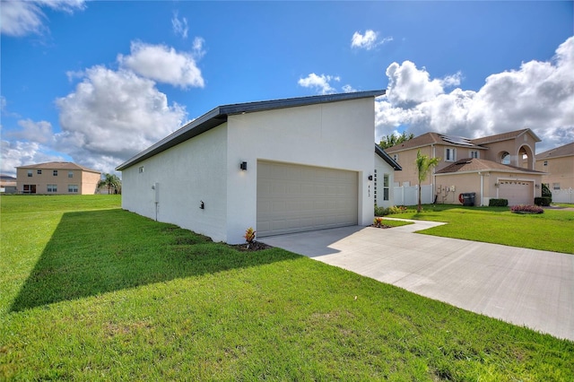 view of home's exterior with a garage and a lawn