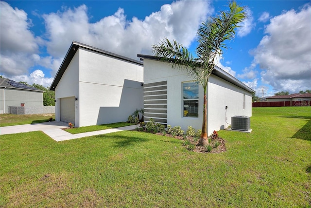 1877 Snapper Dr, Kissimmee, FL 34759 - view of side of property featuring stucco siding, central AC, concrete driveway, and a garage