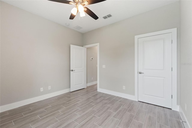 spare room featuring ceiling fan and light hardwood / wood-style flooring