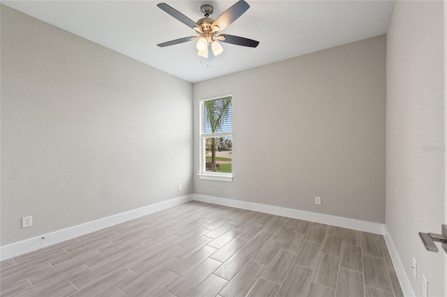 spare room with ceiling fan and light wood-type flooring