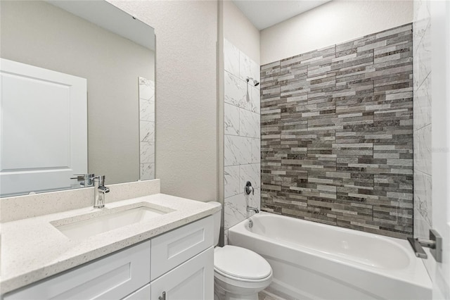 full bathroom with toilet, tiled shower / bath combo, and vanity