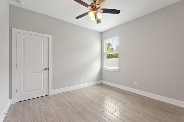 spare room featuring ceiling fan and light wood-type flooring