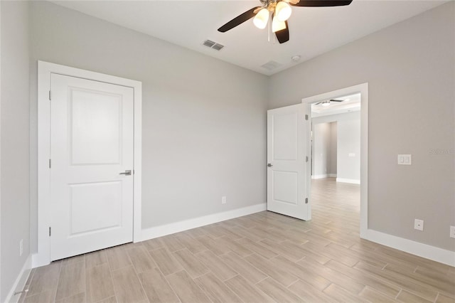 empty room featuring ceiling fan and light wood-type flooring