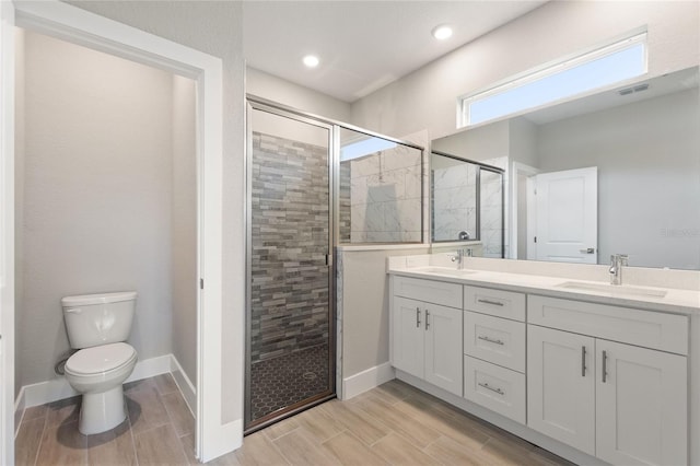 bathroom with an enclosed shower, vanity, and toilet