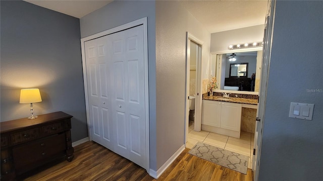 hall featuring sink and dark hardwood / wood-style flooring