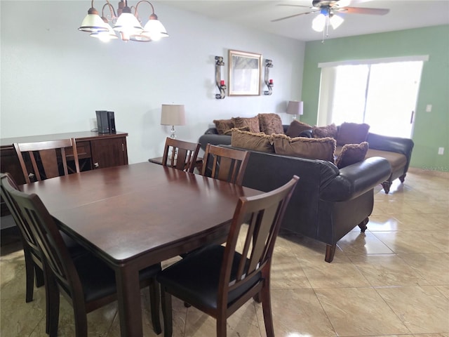 dining room with ceiling fan with notable chandelier