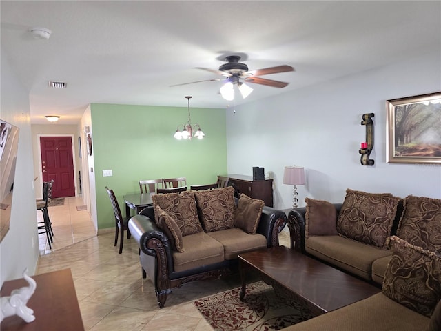 living room with ceiling fan with notable chandelier and light tile patterned flooring