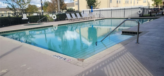 view of swimming pool with a community hot tub