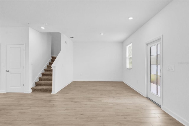 interior space featuring light wood-type flooring and a healthy amount of sunlight