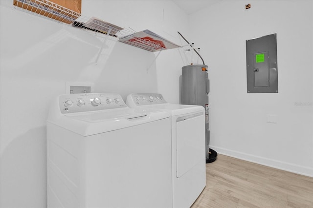 washroom featuring electric panel, separate washer and dryer, light hardwood / wood-style flooring, and electric water heater