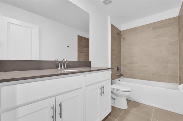 full bathroom with tile patterned flooring, vanity, toilet, and tiled shower / bath