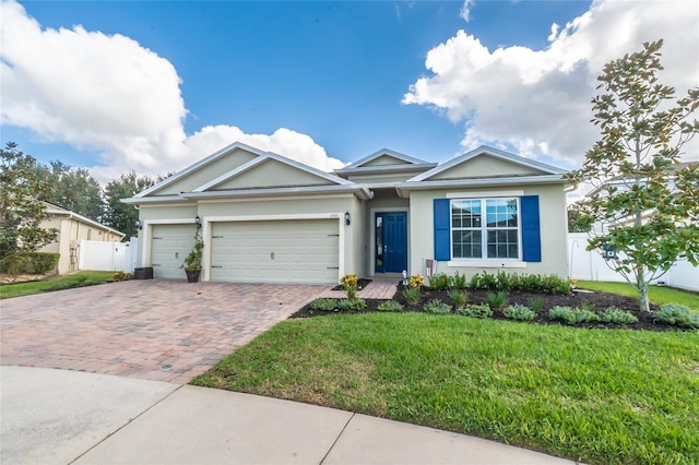 view of front of home featuring a garage and a front yard