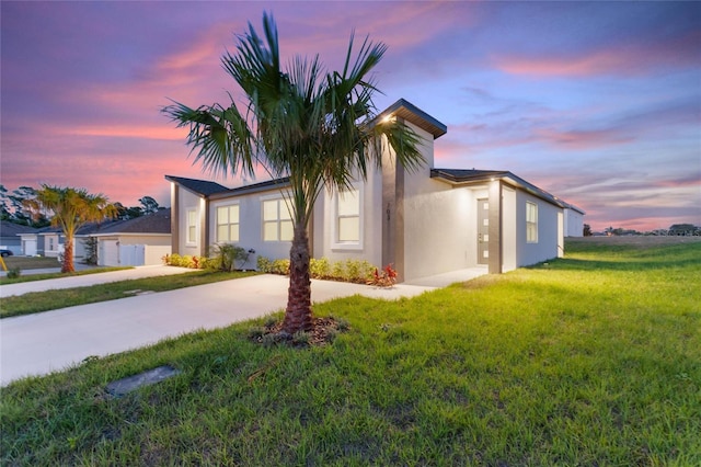 property exterior at dusk with a yard