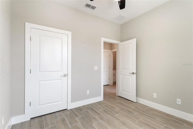 unfurnished bedroom with light hardwood / wood-style floors and ceiling fan