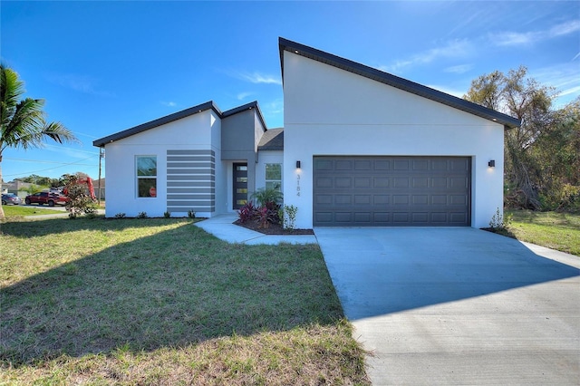 view of front of home featuring a garage and a front yard