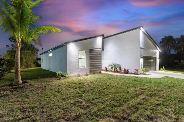 view of front of house featuring a garage and a yard