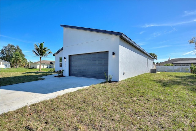 view of property exterior featuring central air condition unit, a garage, and a yard