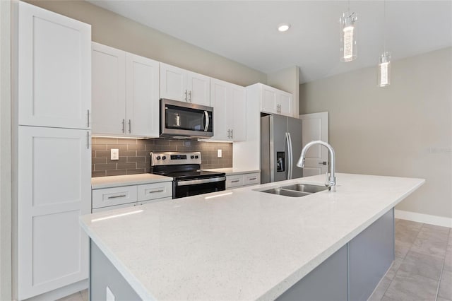 kitchen featuring appliances with stainless steel finishes, sink, and a center island with sink