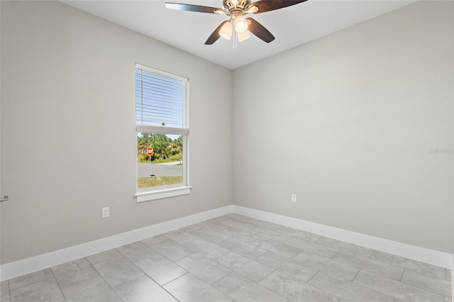 empty room featuring ceiling fan and light tile patterned flooring