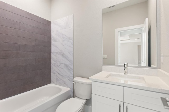 full bathroom with vanity, toilet, and tiled shower / bath