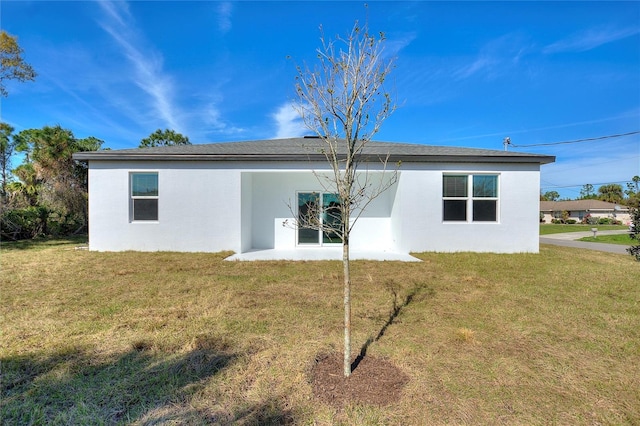 back of house featuring a yard