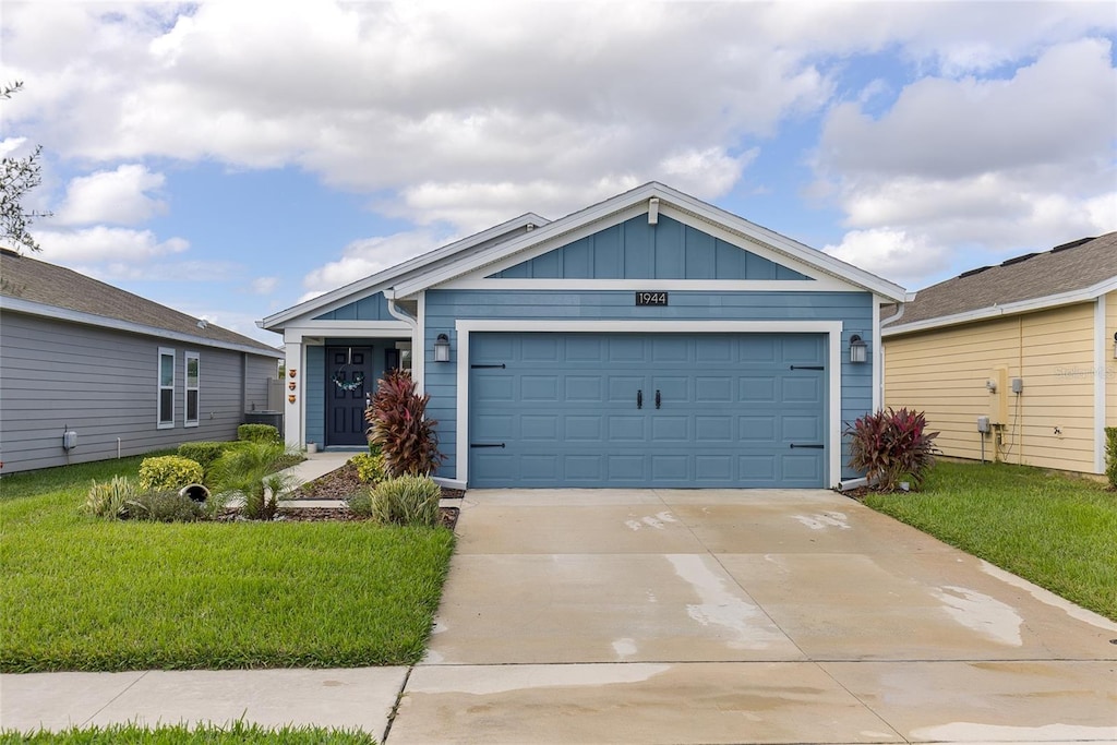 view of front of home with a garage and a front yard