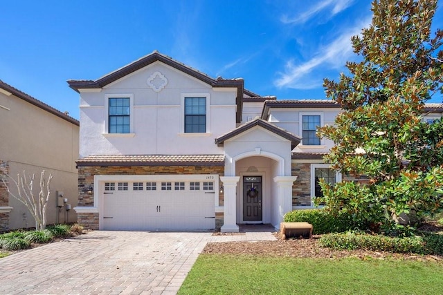 mediterranean / spanish-style home with a garage