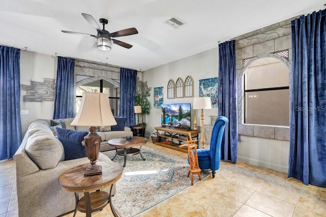 living room featuring light tile patterned floors and ceiling fan