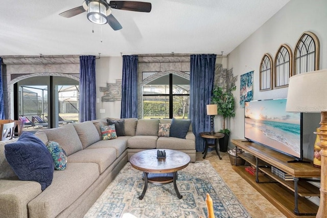 living room featuring a wealth of natural light and ceiling fan