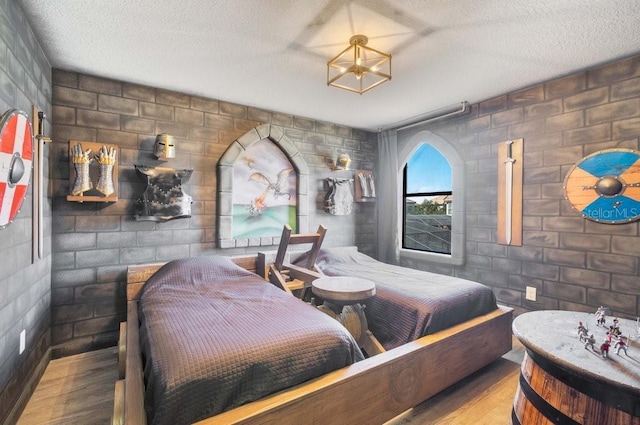 bedroom with light hardwood / wood-style flooring and a textured ceiling