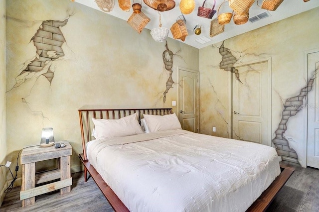 bedroom with ceiling fan and wood-type flooring