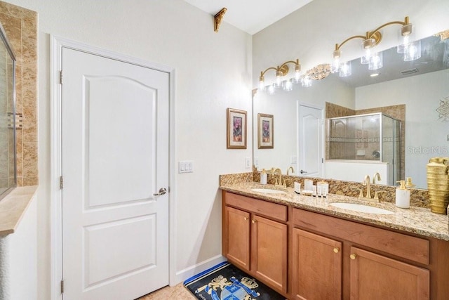 bathroom featuring vanity and a shower with shower door