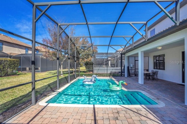 view of pool with a lanai, a patio area, and a lawn